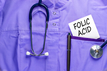 Folic acid symbol. Concept words Folic acid on beautiful white card. Stethoscope and pen. Beautiful...