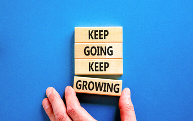 Keep going and growing symbol. Concept words phrase Keep going keep growing on beautiful wooden...
