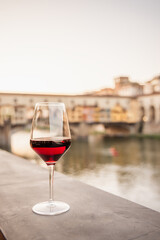 Glass of red wine with old city at the background