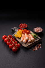 Bowl with shrimps, seafood, rice, oranges, tomatoes with sauce. Bowl with prawns