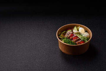 Seafood bowl, tuna tataki fillet slices with rice, oranges, tomatoes and sauce. Tuna bowl