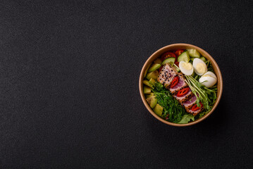 Seafood bowl, tuna tataki fillet slices with rice, oranges, tomatoes and sauce. Tuna bowl