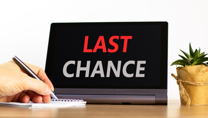 Last chance symbol. Concept word Last chance on beautiful black tablet. Businessman's hand with...