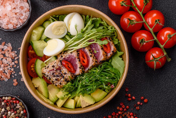 Seafood bowl, tuna tataki fillet slices with rice, oranges, tomatoes and sauce. Tuna bowl