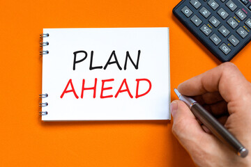 Plan ahead symbol. Concept word Plan ahead on beautiful white note. Businessman's hand. Black...