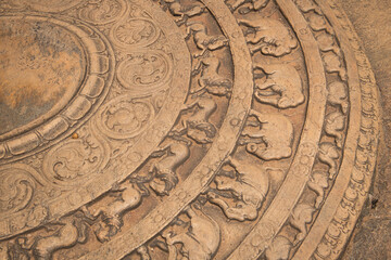 detail of Sandakada Pahana or Moonstone in temple of sri lanka carved semi-circular stone slab feraturing animal motifs