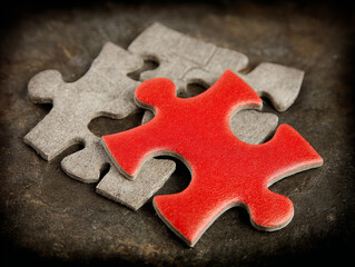 Fototapeta premium Colorful puzzle pieces on a dark surface highlight creativity and problem-solving in a cozy home environment