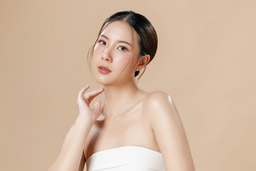 Young Asian woman portrait natural make up cosmetic on face radiant eyes lip gloss happy touch her...