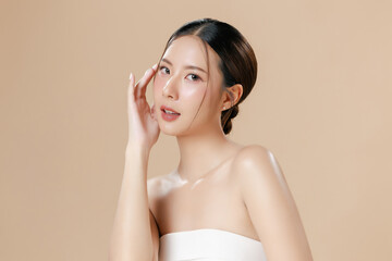 Young Asian woman portrait natural make up cosmetic on face radiant eyes lip gloss happy touch her...