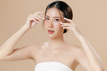Young Asian woman portrait natural make up cosmetic on face radiant eyes lip gloss happy touch her...