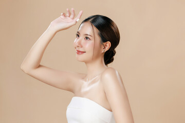 Young Asian woman portrait natural make up cosmetic on face radiant eyes lip gloss happy touch her...