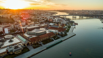 Aerial drone view of Halic Congress Center in Istanbul, modern architecture surrounded by cityscape and waterfront.
