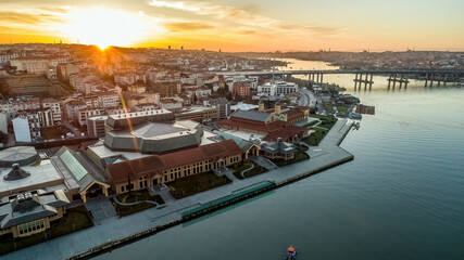 Aerial drone view of Halic Congress Center in Istanbul, modern architecture surrounded by cityscape and waterfront.