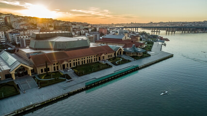 Halic Congress Center in Istanbul captured by drone at sunrise, featuring urban skyline and modern buildings.