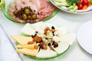 Cheese platter with nuts and olives