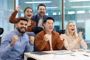 A team of colleagues expressing joy and success in a contemporary office setting, reflecting teamwork, collaboration, and achievement.