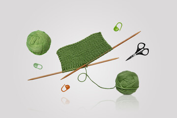 Tools for knitting warm clothes: scissors, green ball of thread, stoppers, and knitting needles...