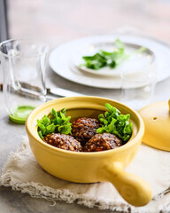 Savor the Delicious Meatballs nestled in a Bright Yellow Pot