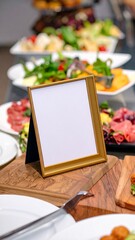 Fototapeta premium Buffet Table Display with Blank Gold Frame Salad and Meat Selections