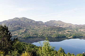 Fototapeta premium Ben Venue and it's lower neighbour Beinn Bhreac reflected in Loch Katrine. Loch Lomond and the Trossachs National Park, Southern Highlands of Scotland.