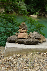 Photo of several rocks piled up with a lake in the background