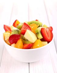 Colorful fruit salad in a white bowl