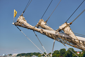 Tall ship bowsprit rigging with furled jib sails off Rostock harbor