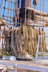 Two belaying pin racks with ship ropes, mast and blue deck hatch