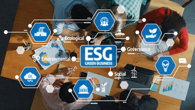 Professionals collaborate on an ESG strategy for sustainable business, utilizing visual icons to represent environmental, social, and governance themes promoting innovation and growth. Amity
