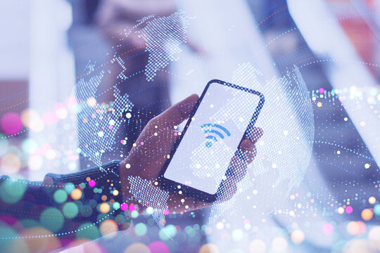 Hands holding a smartphone displaying a Wi-Fi in supermarket. Concept with digital globe and stars, symbolizing global connectivity and wireless technology.