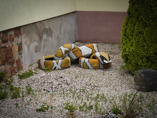 old tire artwork in garden