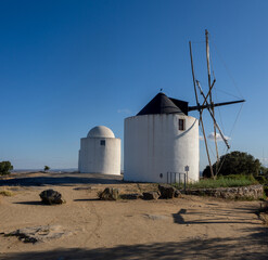 Obraz premium Old windmills atop a granite hill in Alto De São Bento near Evora, Alentejo, Portugal