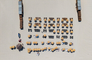 Sea relax under beach umbrella. Travel to sea. Luxury resort. Aerial top view of sand beach with...