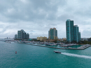 Aerial view of luxury yachts in Miami marina. Scenic panorama of boats and skyscrapers in Miami...
