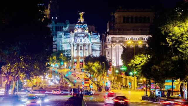 Night view of the metropolis building in madrid, spain, with traffic on gran via