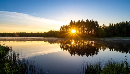 Lake Reflection at Sunrise with Sunburst Through Trees