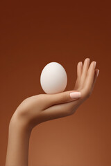 hyperrealistic ultraminimalist scene featuring closeup of hand gently cradling single egg