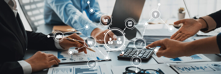 A dynamic business meeting showcases teamwork and technology, emphasizing data analysis and strategic planning in a modern office environment. Amity