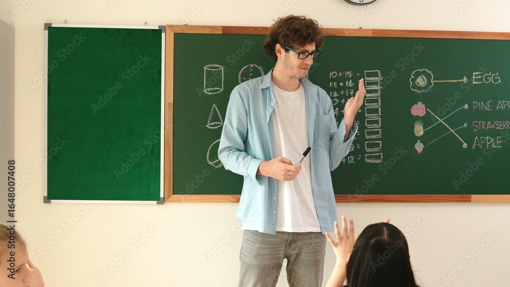 Poster professional mentor looking around classroom while standing in front of blackboard with math formula