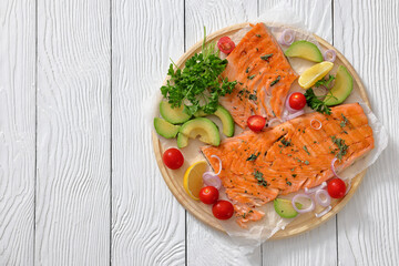 grilled salmon fillet on circle wooden board