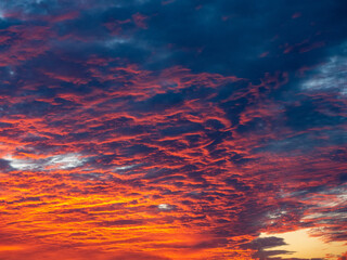 Vibrant sunset sky, dramatic clouds, fiery colors, nature's beauty