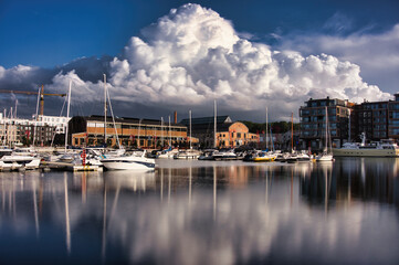 Scenic View of Noblessner Marina in Tallinn, Estonia - Luxury Yachts and Dramatic Clouds