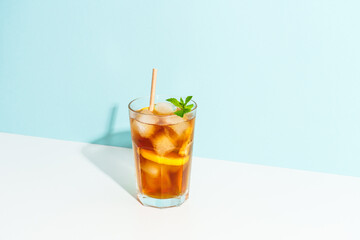 Summer cold drink on colored background with hard shadows.
