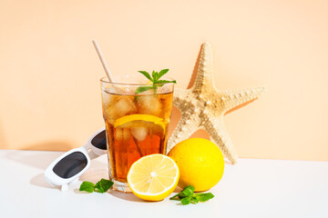 Summer iced cocktail drink with sunglasses and sunny shadows.