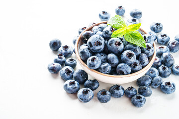 Blueberries in the bowl on white.