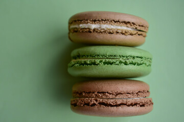 Cake french macaroon on green background. Sweet and colorful dessert. Tasty colorful macaroons. Food background.