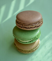 Cake french macaroon on green background. Sweet and colorful dessert. Tasty colorful macaroons. Food background.