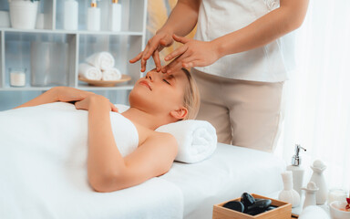 Caucasian woman enjoying relaxing anti-stress head massage and pampering facial beauty skin...