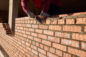 Bricklayer Hard at Work Ongoing Construction of a Residential Building Structure