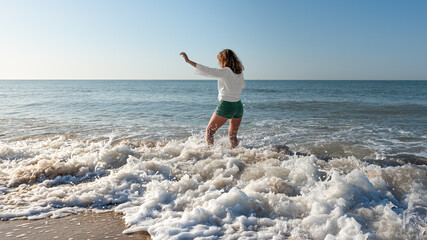 Fusion of freedom between the woman and the sea in motion